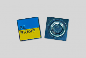 Metal pin with inscription BE BRAVE blue-yellow