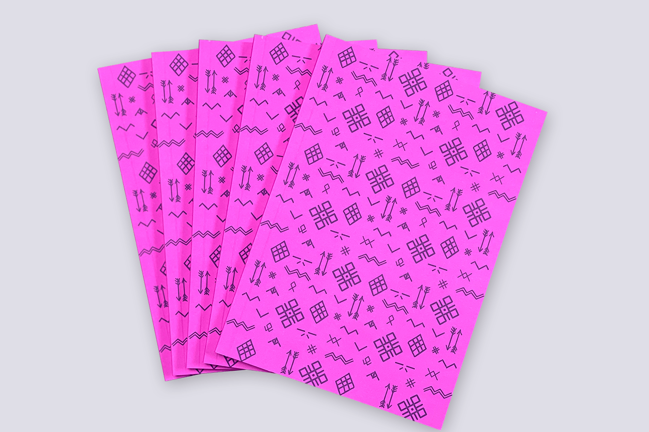 Pink notebook with the image of runes